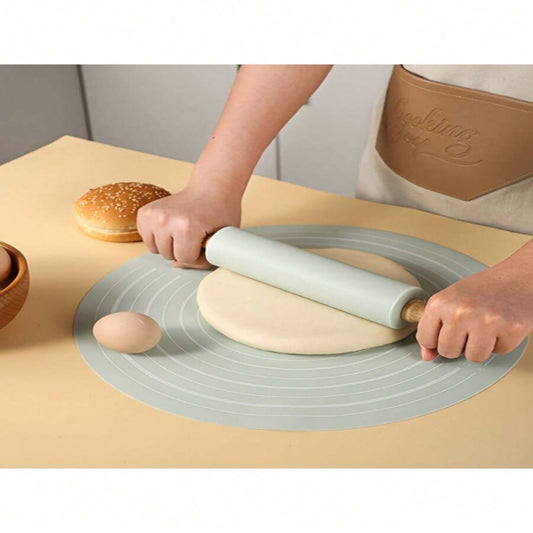 Person rolling dough on a silicone baking mat with a burger in the background