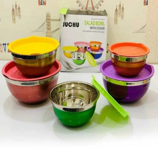 Set of colorful salad bowls with lids on a white surface, with a Juhu brand box in the background.
