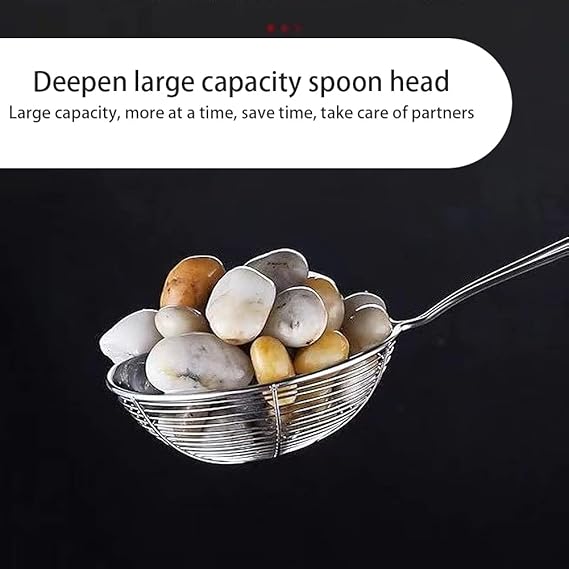 Spoon with a large capacity filled with stones on a black background