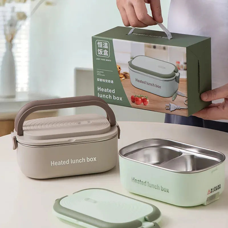 Heated lunch box with packaging and additional containers on a table.