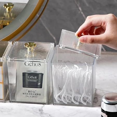 Hand reaching into a clear container with toothbrushes, featuring the brand 'Gehos'.