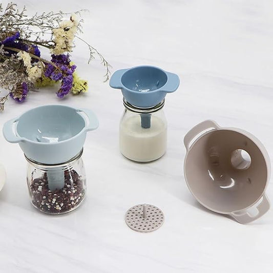 Silicone strainers and jars on a white surface with flowers in the background