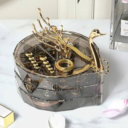 Decorative jewelry box with gold swan design on a white surface