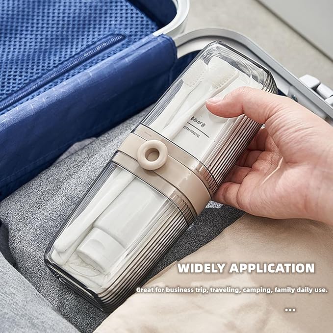 Hand holding a travel-sized toiletry set with a suitcase in the background