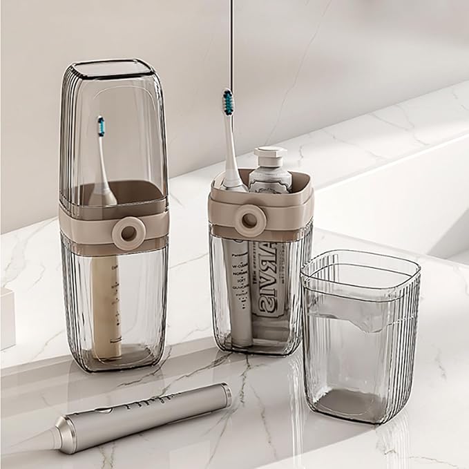 Clear and beige toothbrush holders with toothbrushes on a marble surface