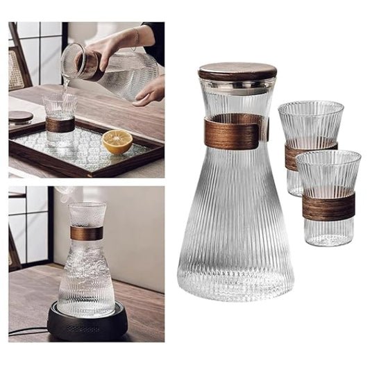 Clear glass carafe with wooden accents and matching glasses on a white background.