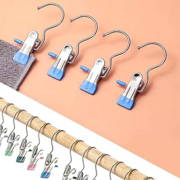 Set of metal hangers with blue clips on a peach background