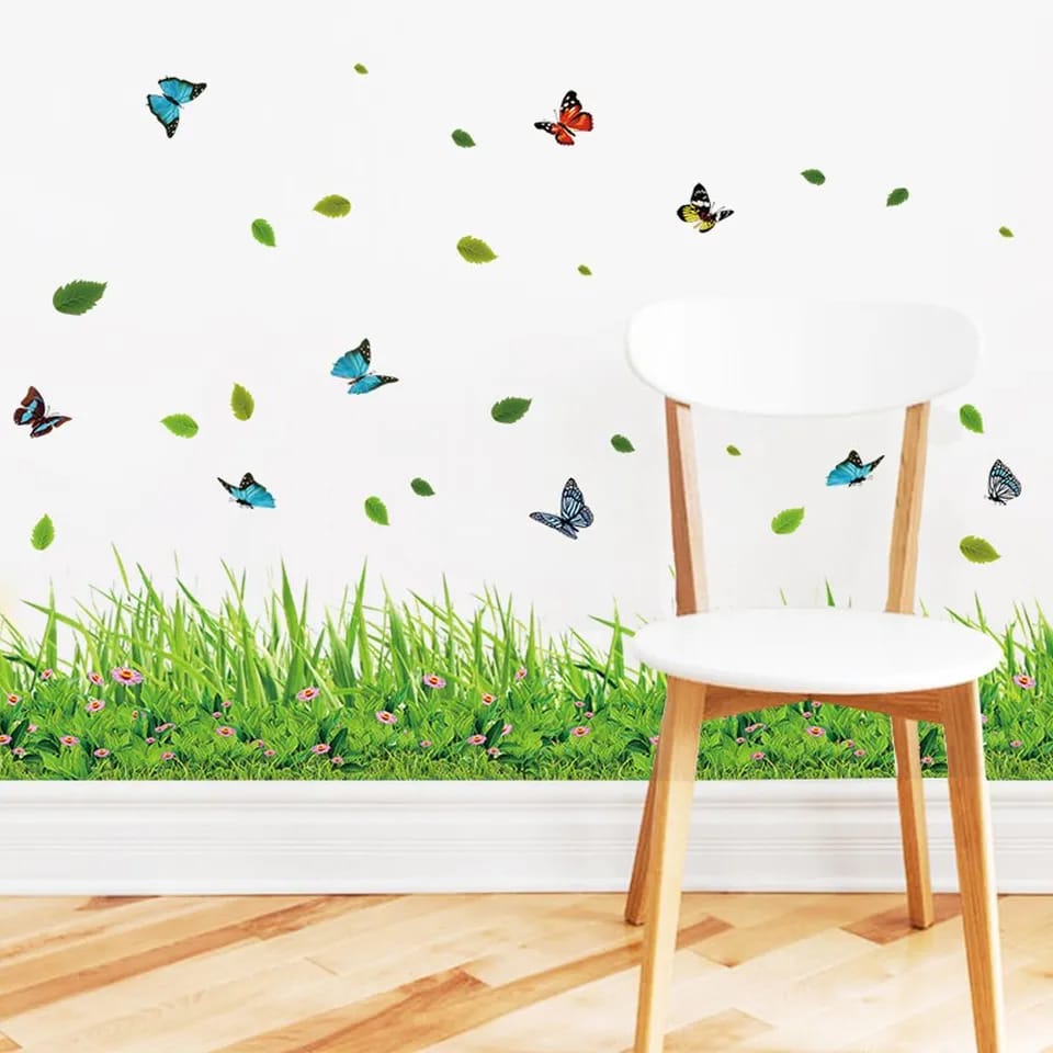 Chair with grass and butterfly wall decals on a white wall.