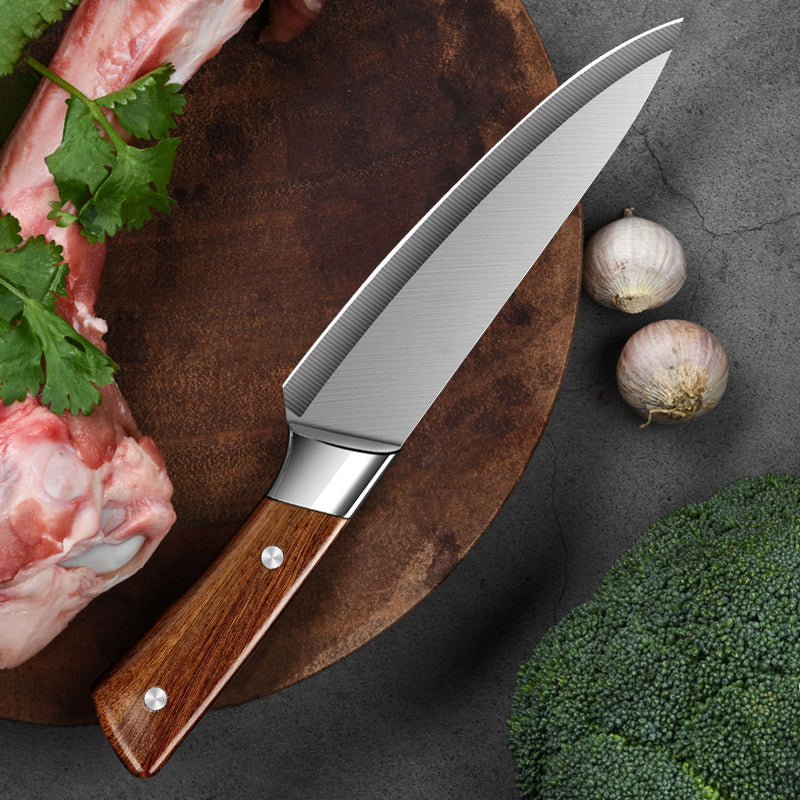 Chef's knife with wooden handle on a cutting board with vegetables and meat.