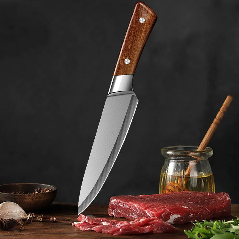 Knife with wooden handle on a dark background with raw meat and spices.