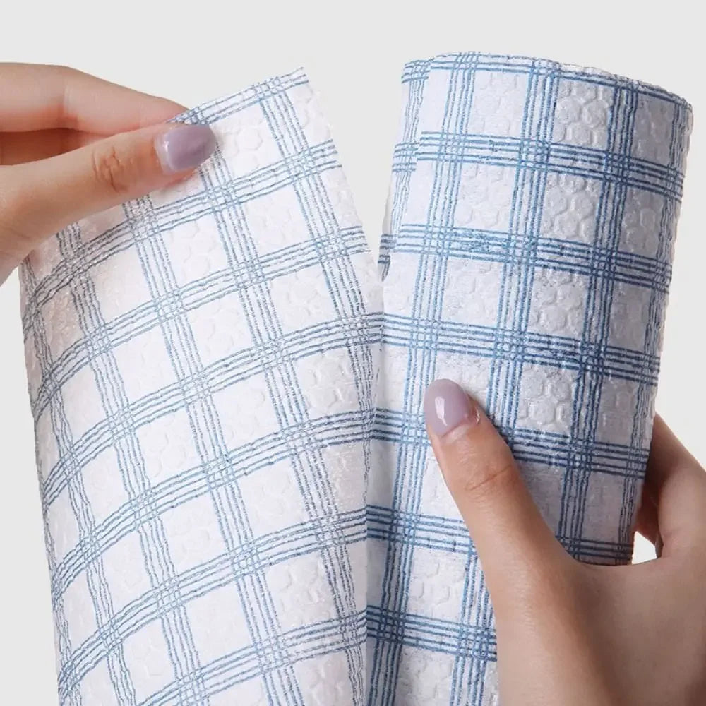 Two blue and white checkered cloths held by a person against a light background