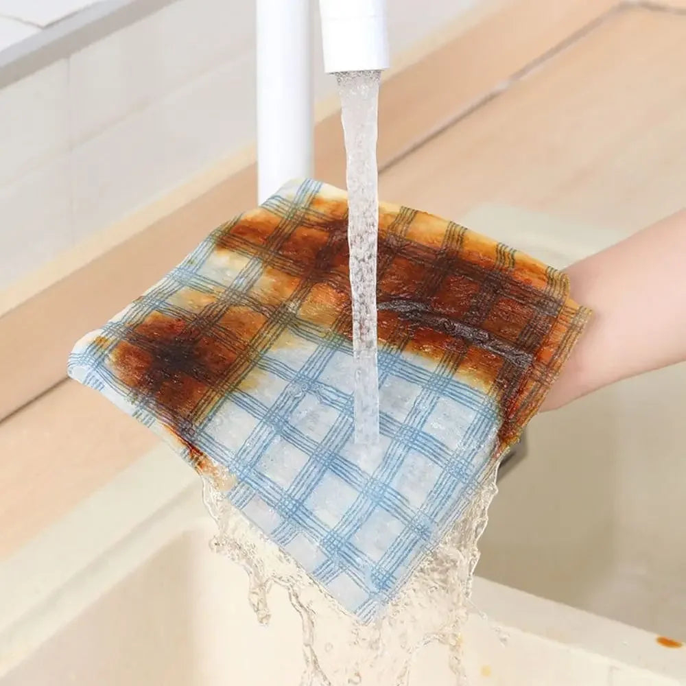 Person washing a checkered cloth under running water from a faucet.