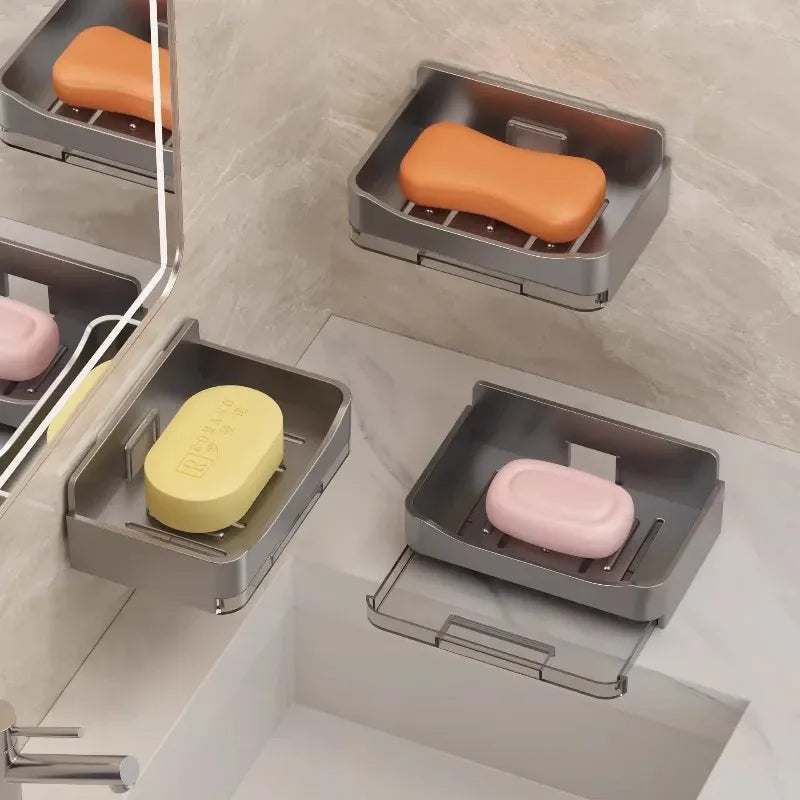 Multiple soap dishes holding bars of soap in a bathroom setting.