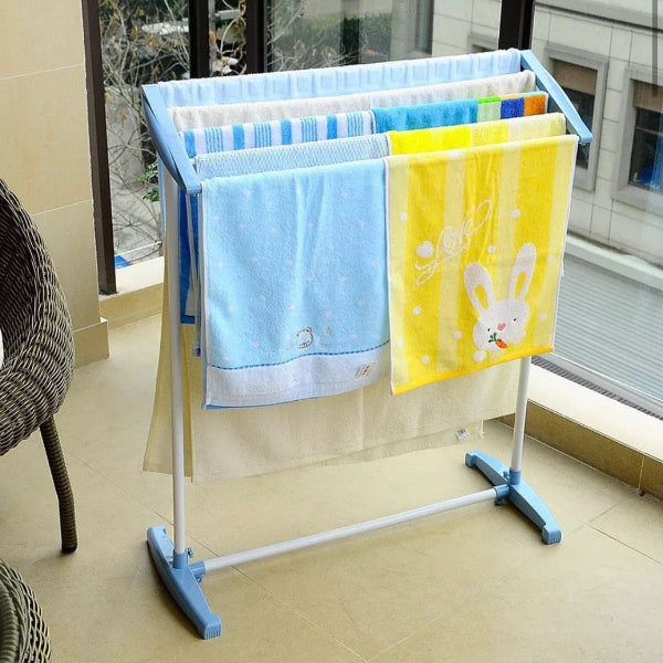Towel rack with blue and yellow towels on a tiled floor
