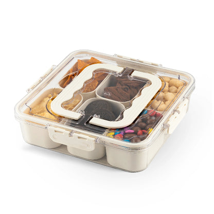 Bento box with compartments containing various snacks on a white background