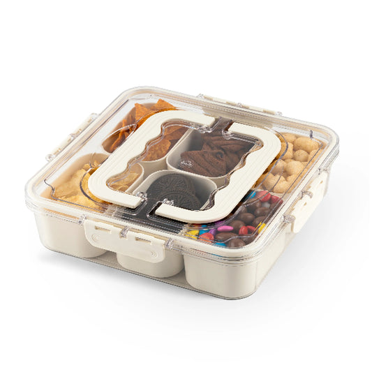 Bento box with compartments containing various snacks on a white background