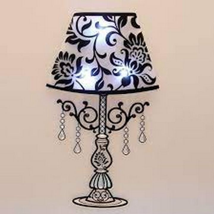 Decorative wall decal of a black and white floral-patterned lamp with hanging crystals on a beige background.