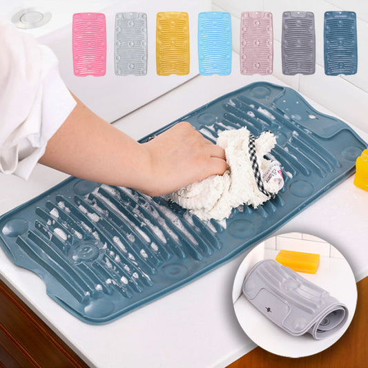 Person washing a dish on a blue silicone mat with various color options displayed above.