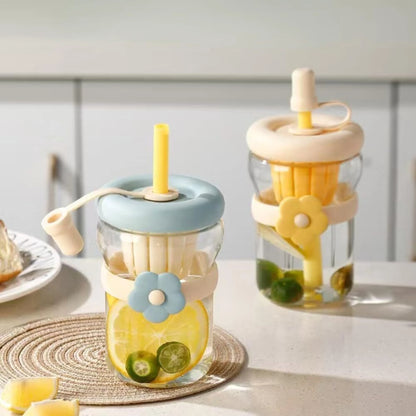 Two glass jars with colorful lids and straws on a light surface.