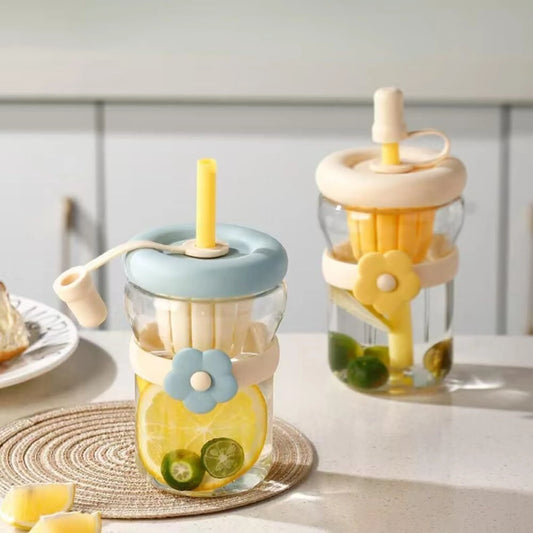 Two glass jars with colorful lids and straws on a light surface.