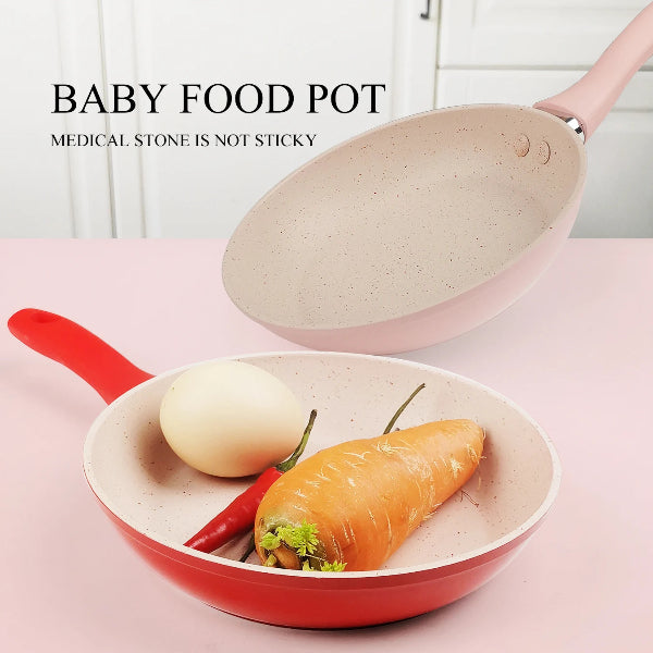 Baby food pot with a lid containing an egg and carrot on a pink surface.