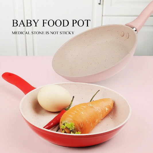 Baby food pot with a lid containing an egg and carrot on a pink surface.
