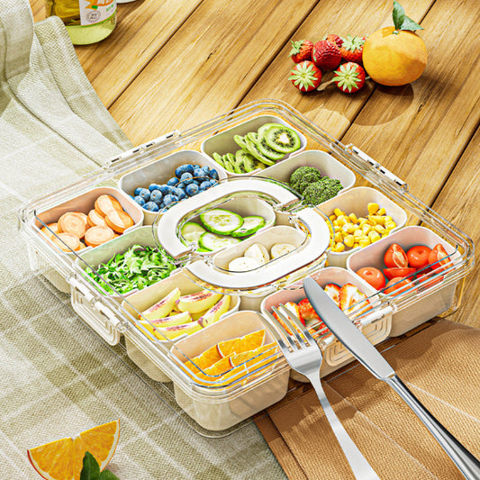 Transparent bento box with compartments filled with various fruits and vegetables on a wooden table.
