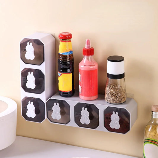 Wall-mounted spice rack with various bottles on a beige wall.