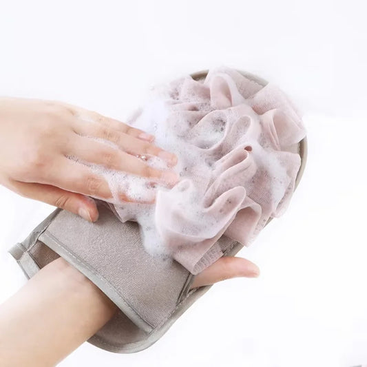 Hand scrubbing a soapy washcloth with a white background