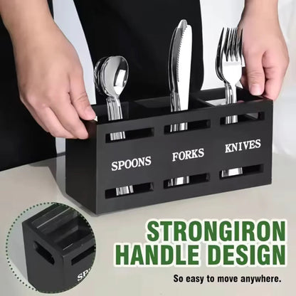 Black cutlery organizer with labeled compartments for spoons, forks, and knives on a neutral background.