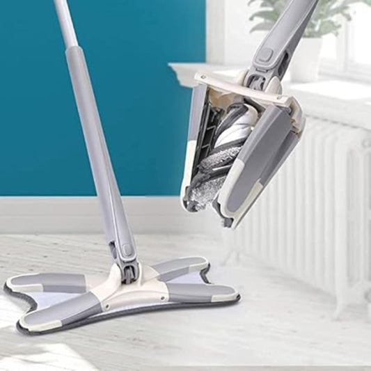 Gray mop with a cleaning head on a white floor against a blue wall.