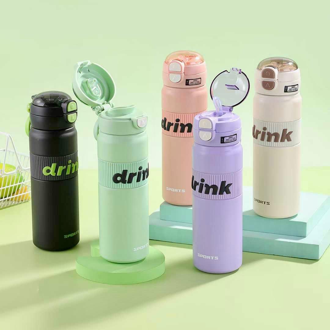 Set of colorful water bottles with 'drink' text on a light green background