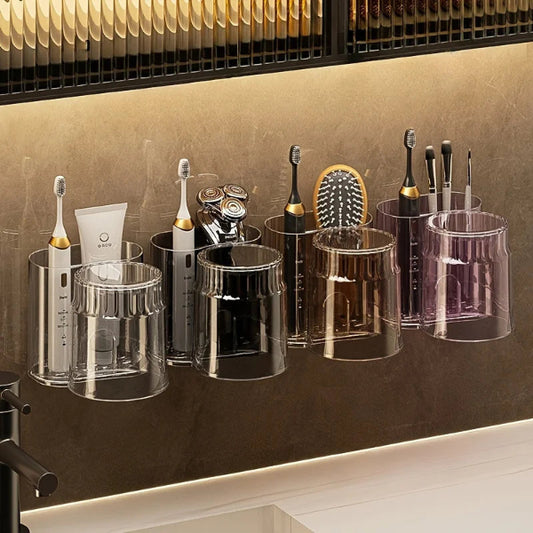 Set of toothbrushes and dental tools in clear holders against a brown wall.