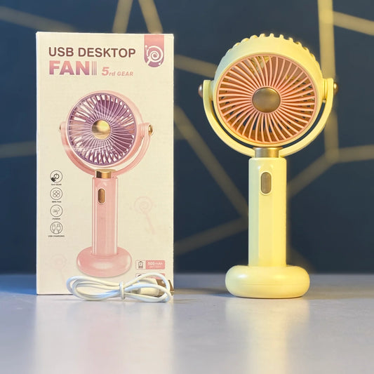 Yellow USB desk fan with packaging on a reflective surface