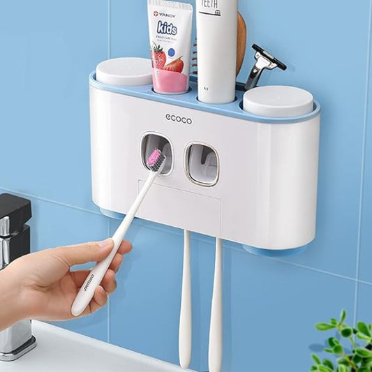 Wall-mounted toothbrush holder with toothbrushes and toothpaste against a blue tiled wall.