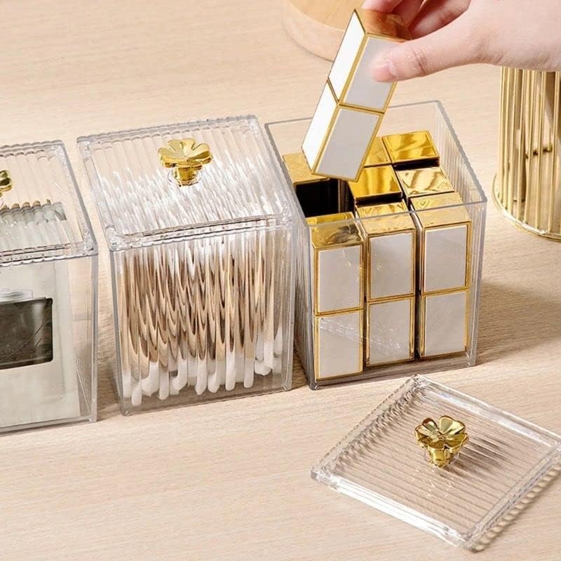 Gold and clear decorative boxes on a wooden surface