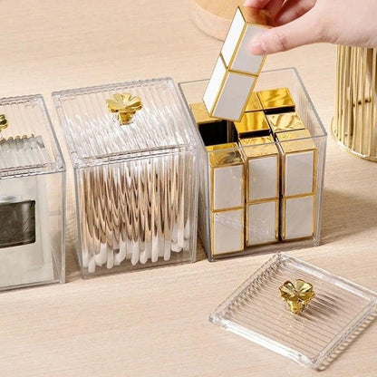 Gold and clear decorative boxes on a wooden surface