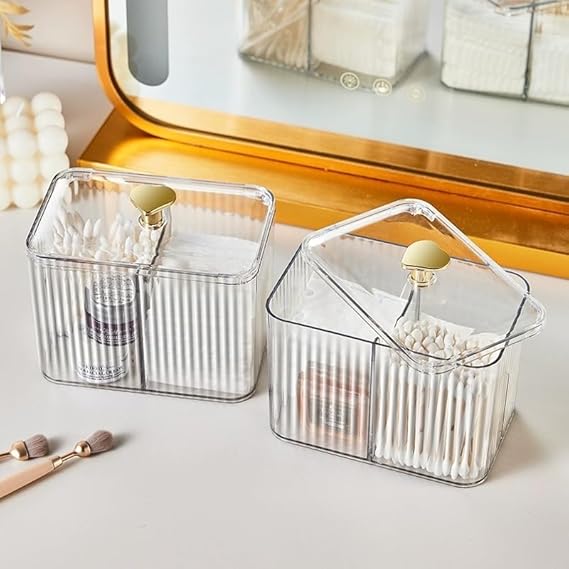 Two clear plastic storage containers with lids on a vanity table.