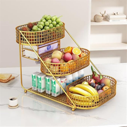 Gold three-tiered fruit basket organizer with fruits on a kitchen counter.