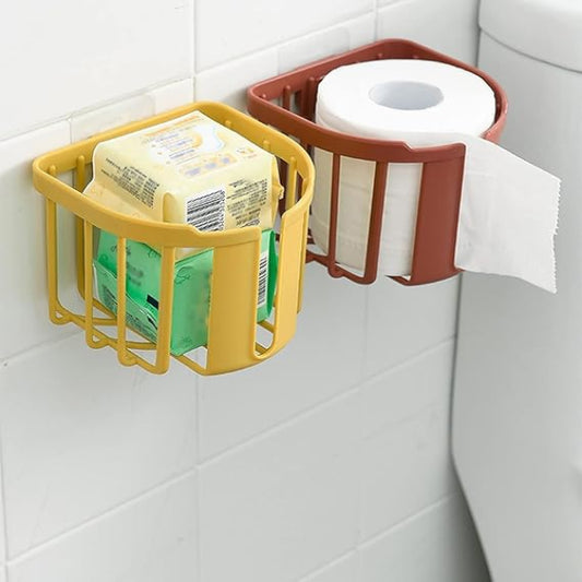 Yellow and red wall-mounted storage holders with soap, paper towels, and toilet paper on a tiled bathroom wall.