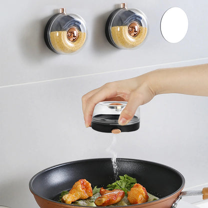 Person seasoning food in a pan with a salt shaker on a white background