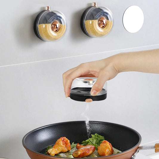 Person seasoning food in a pan with a salt shaker on a white background