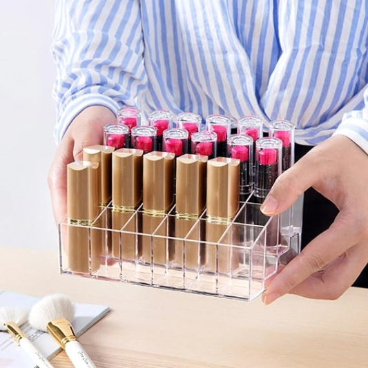 Person holding a clear acrylic lipstick organizer with various lipsticks.