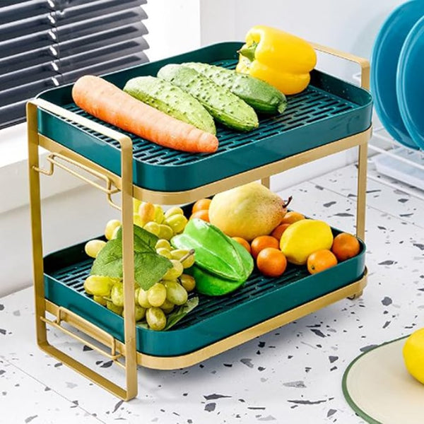 Two-tiered vegetable and fruit organizer with fresh produce on a kitchen counter.