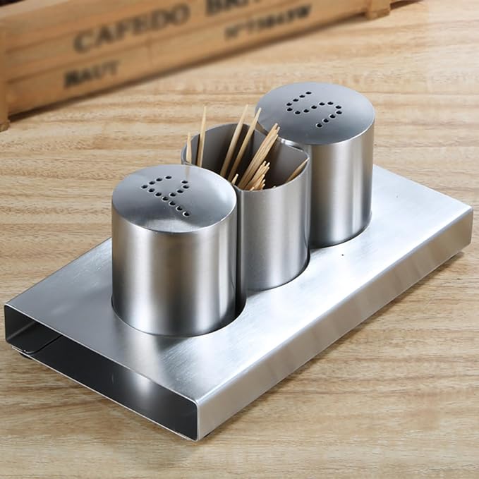 Stainless steel condiment set with toothpick holder on a wooden surface