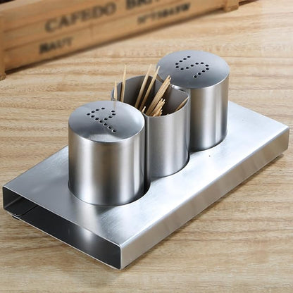 Stainless steel condiment set with toothpick holder on a wooden surface