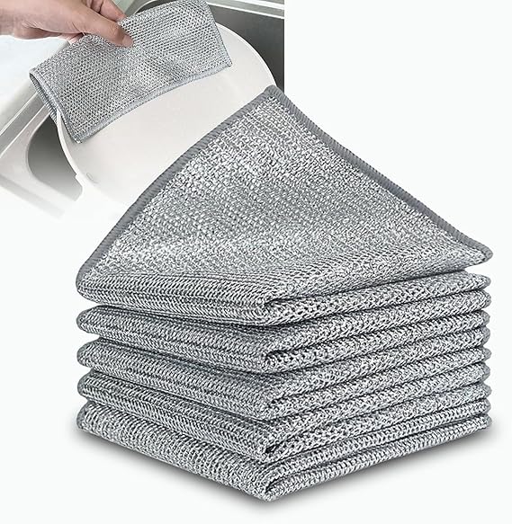 Stack of gray cleaning cloths with a close-up of one being used on a white surface.