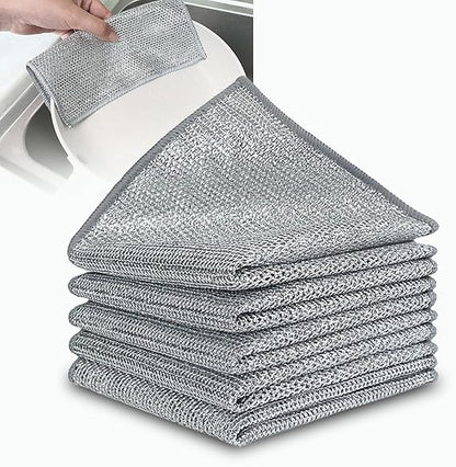 Stack of gray cleaning cloths with a close-up of one being used on a white surface.