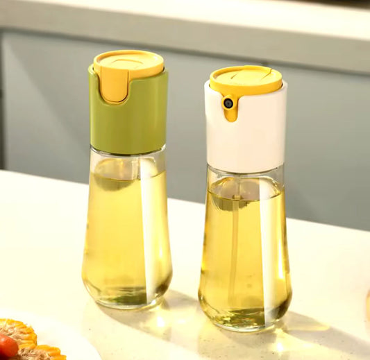 Two glass bottles with yellow lids on a light surface.