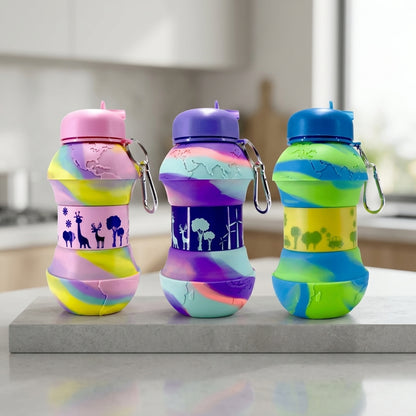 Three colorful water bottles with patterned bands on a kitchen counter.